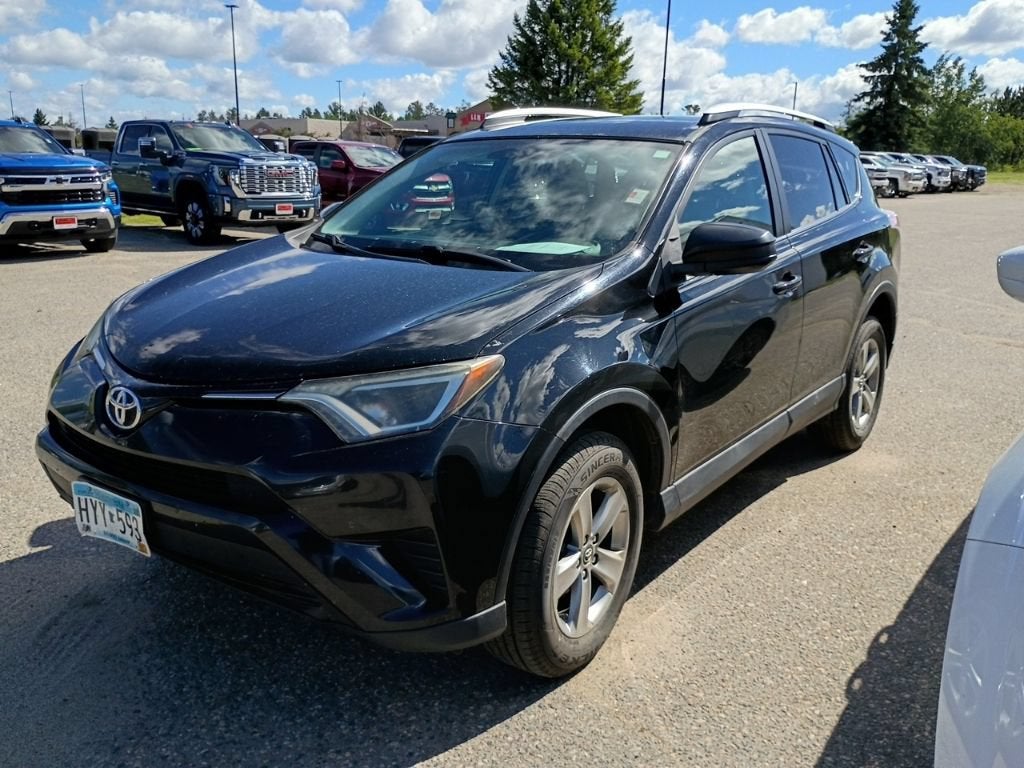 2016 Toyota RAV4 LE in Black — front three-quarter view